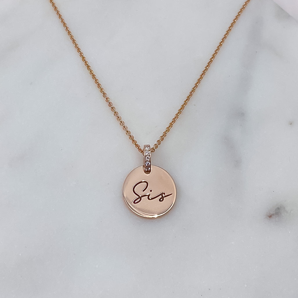 Initial medallion and diamonds